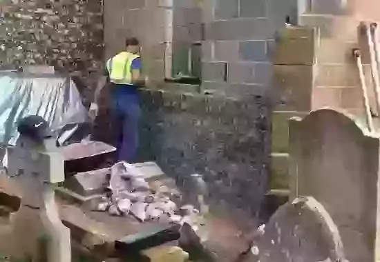 The craftsman makes progress on the flint walls